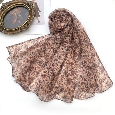 This Long Scarf Features a Misty Floral Design As Its Core, And Is Available in Multiple Color Schemes Such As Dark Green, Brown, Gray, And Blue. The Plant Textures Are As Delicate As a Hazy Watermark